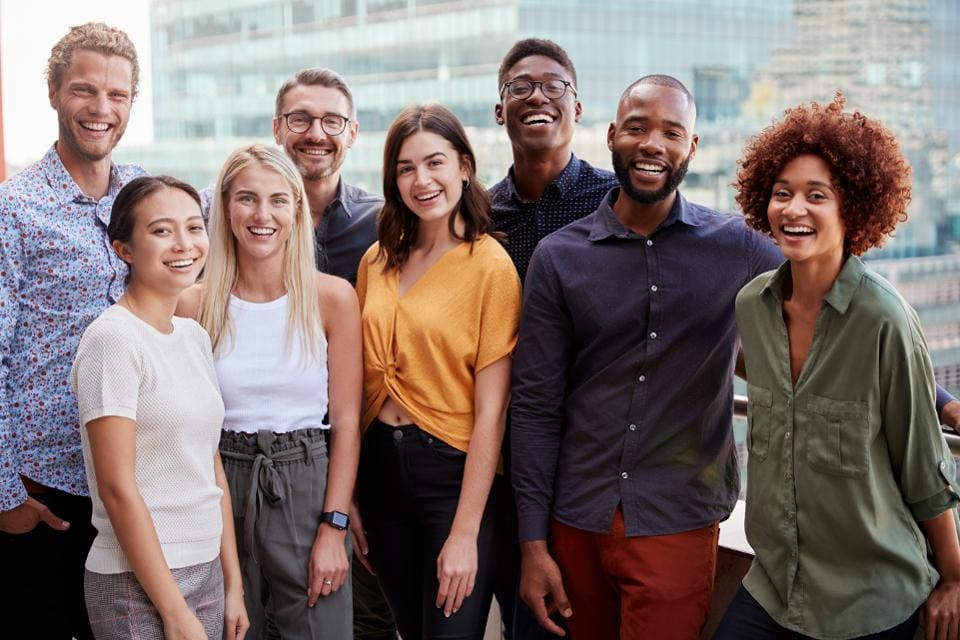 Eight people in a group photo.