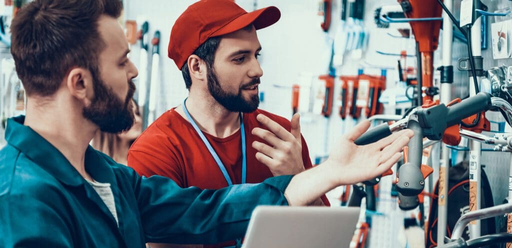 Salesmen check power tools inventory.