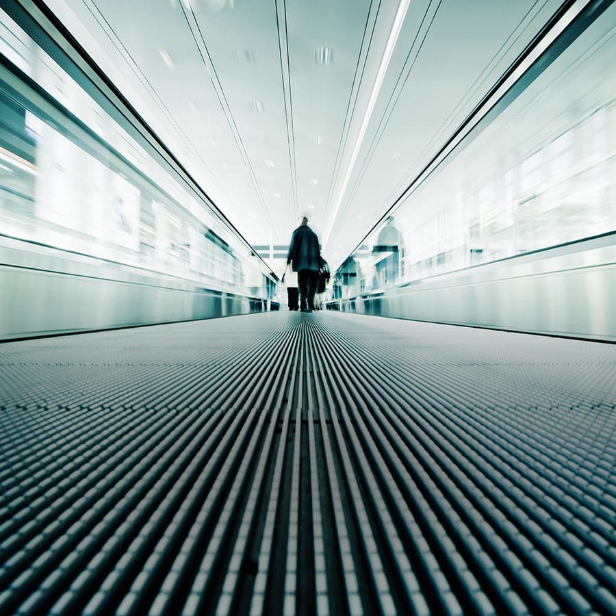 Moving walkway view of airport visitor, representing Federal Aviation Administration.