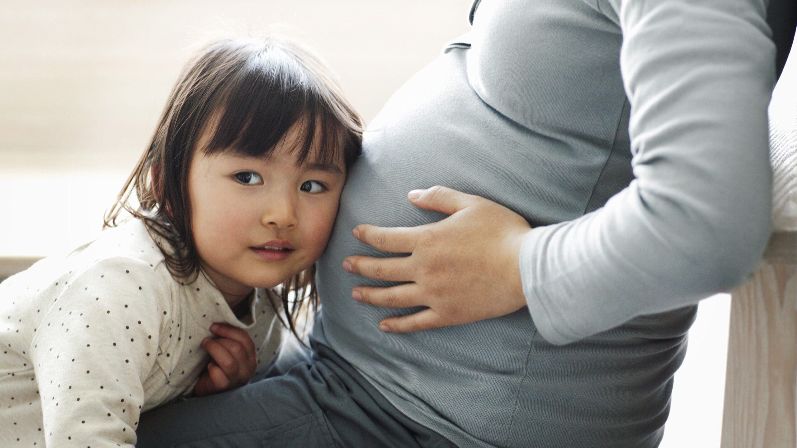 Child and pregnant women in CVS Health promotional image.